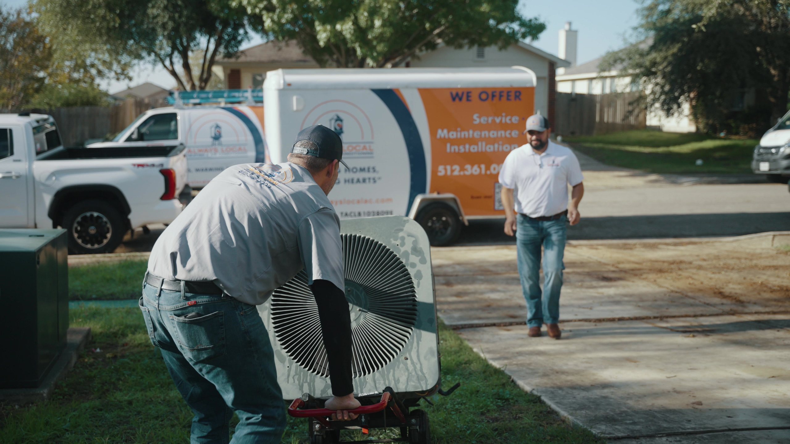 Always Local technicians and their branded trailer at a Central Texas home